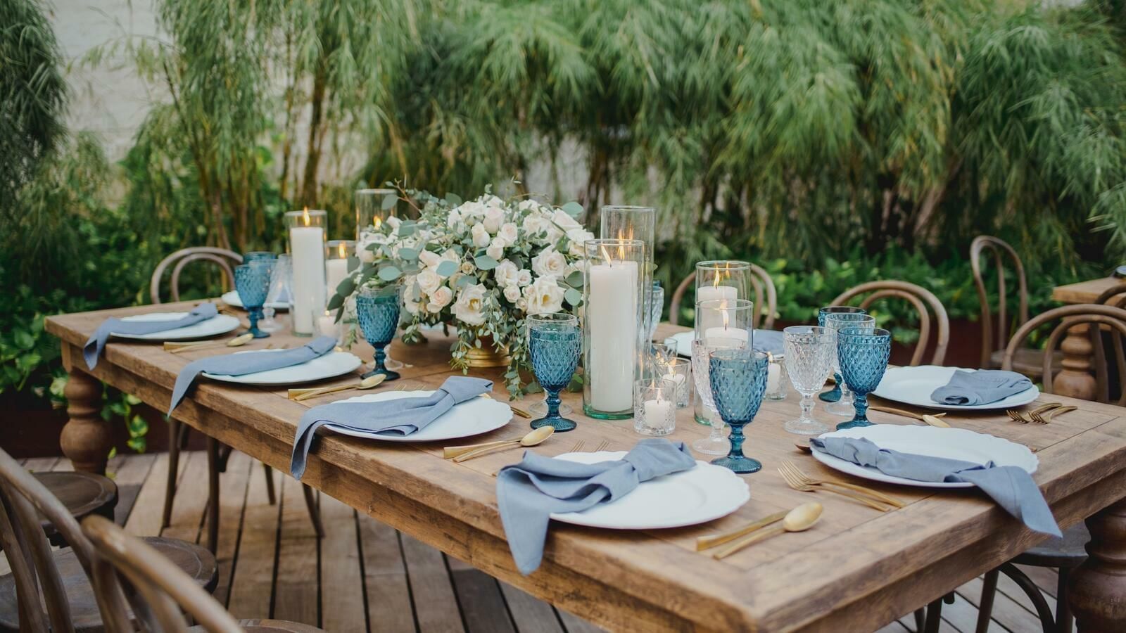 Arranged outdoor dining table with flower décor and candles at The Explorean Cozumel