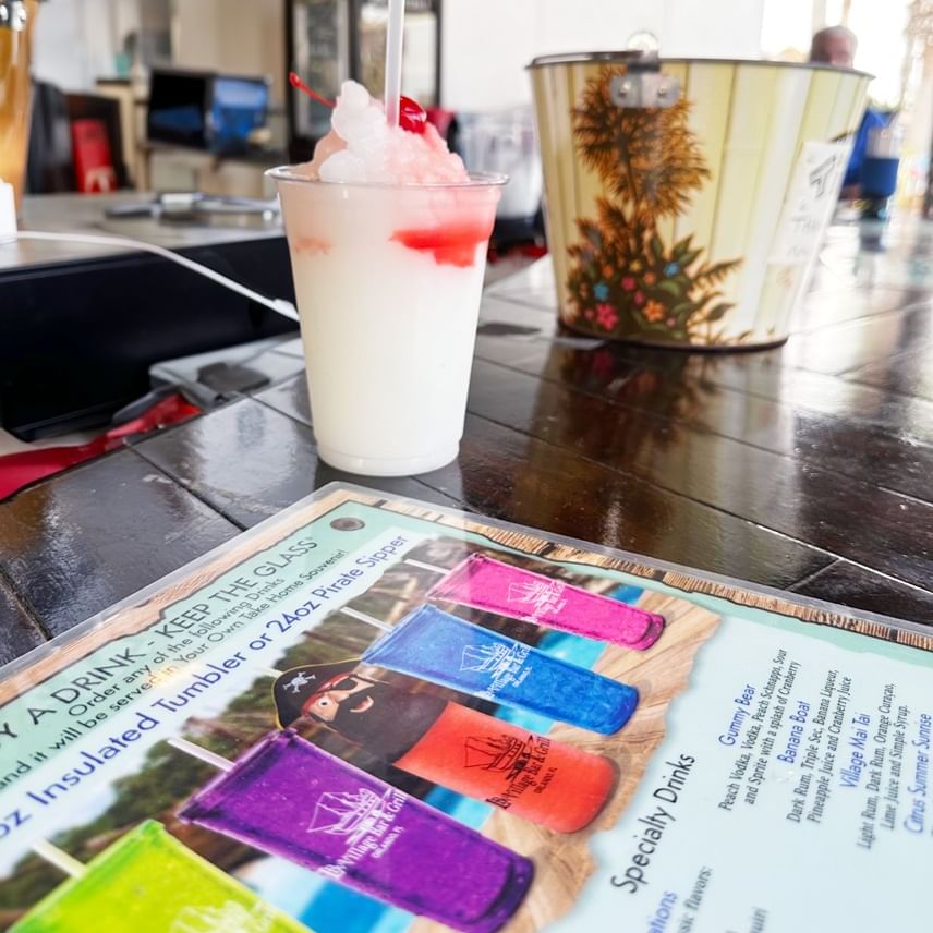 Drink served on countertop with menu in LBV Village Bar & Grill at Lake Buena Vista Resort Village & Spa