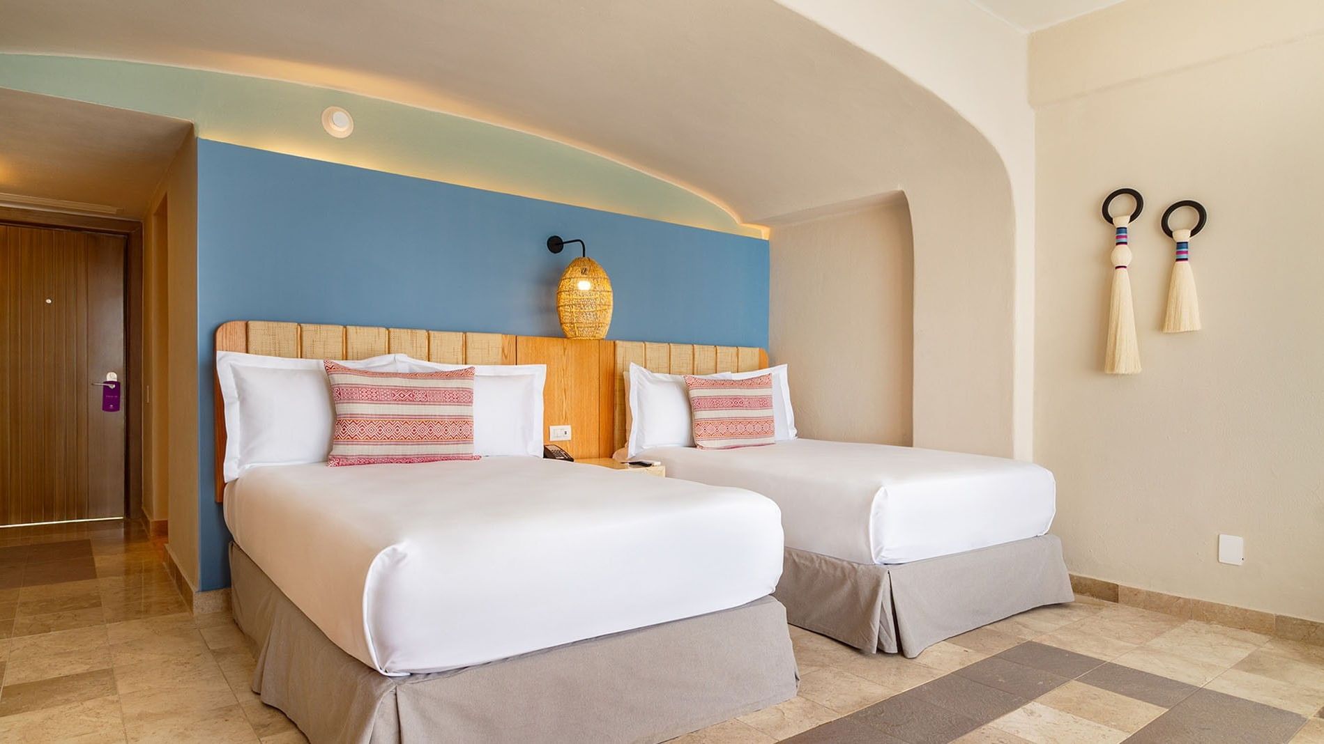Ocean View 2 Double Deluxe Superior with cozy beds, blue accent wall & woven pendant lamps at Camino Real Acapulco Diamante
