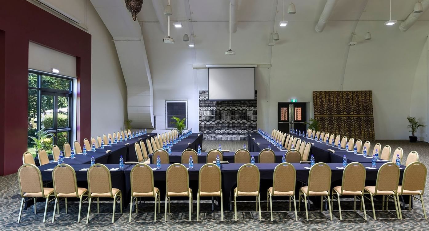U-shaped conference setup with water bottles & projector screen and chandelier at warwick le lagon-vanuatu
