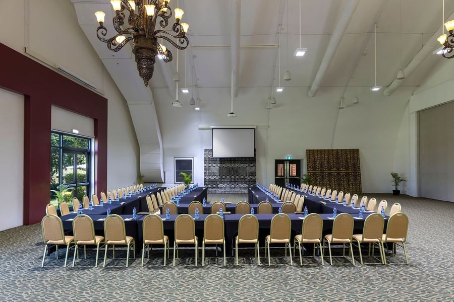 U-shaped conference setup with water bottles & projector screen and chandelier at warwick le lagon-vanuatu