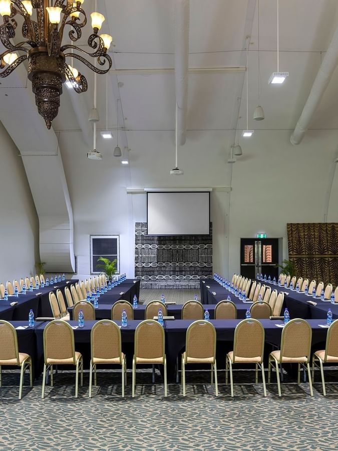 Large conference room with a U-shaped table by tan chairs under a ceiling in Farea Pacifik at Warwick Hotels & Resort