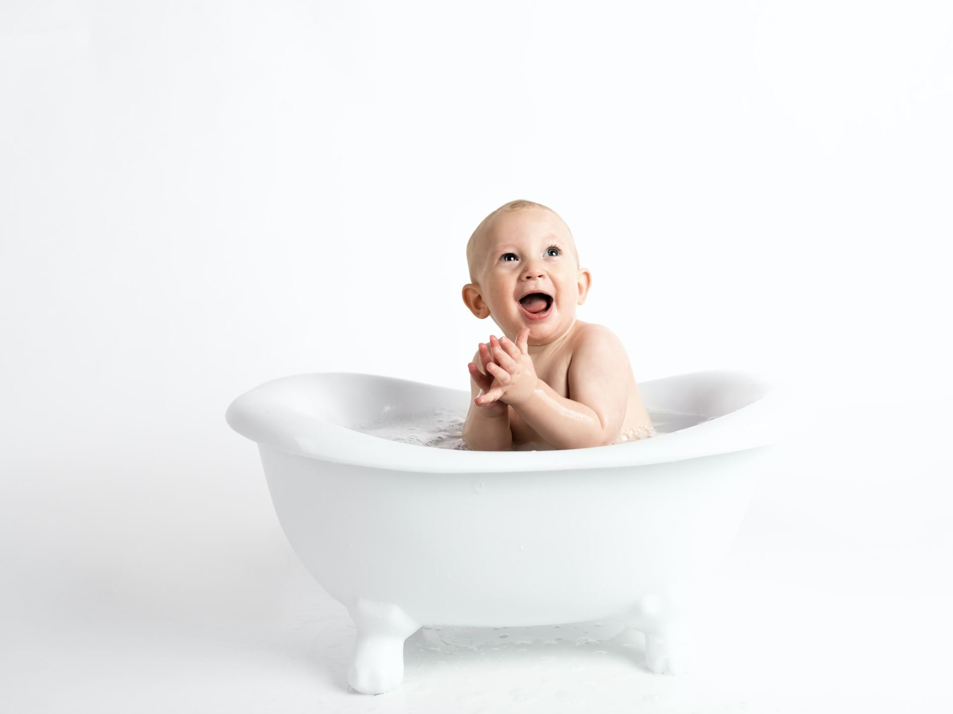 Smiling baby in a baby bath tub at Duparc Contemporary Suites