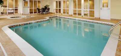 Relaxing indoor swimming pool area with seating at The Wildwood Hotel