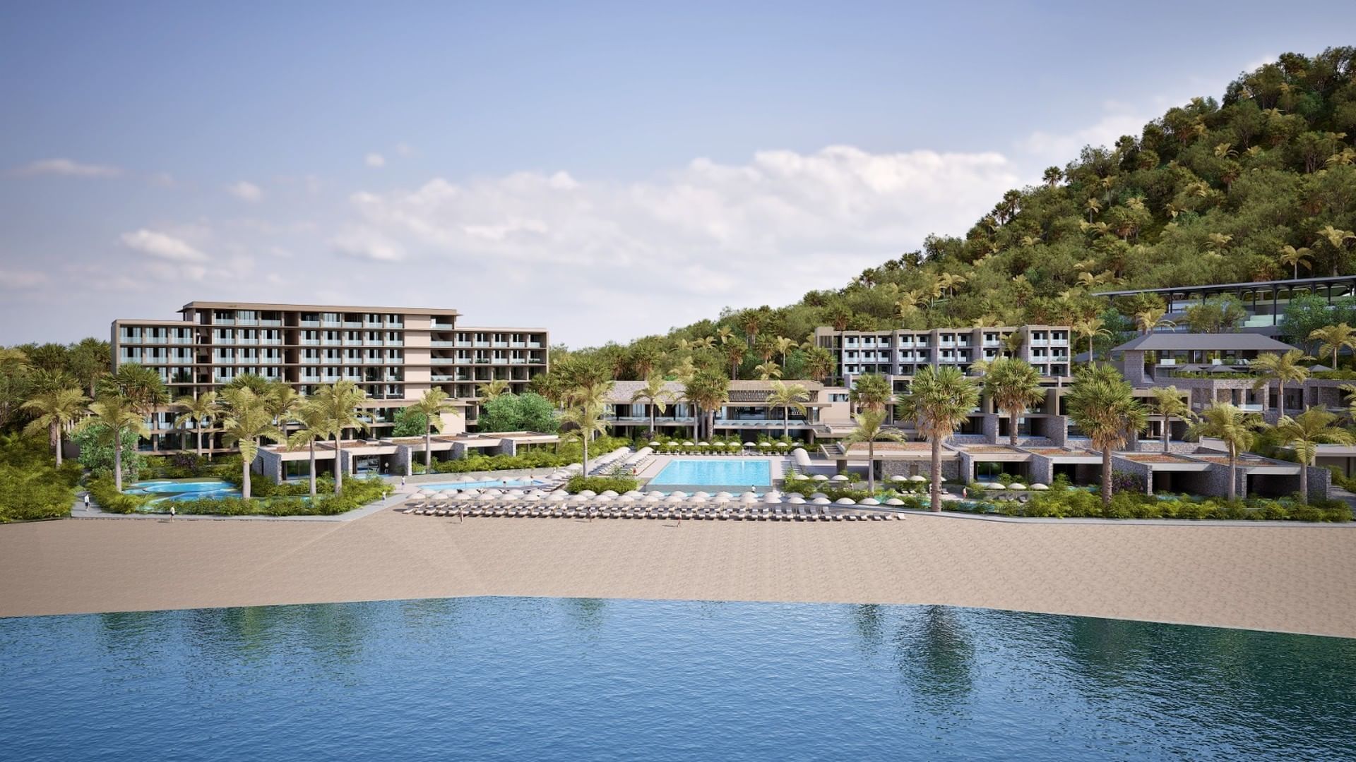 Beautiful A'ila Resorts beachfront view, with resort buildings, a pool, and a lush green hillside