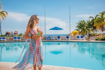 Woman by the pool enjoying the view at Holiday Inn Montego Bay