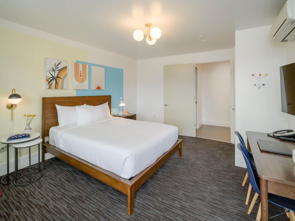 Bed and carpeted floors with furniture in Superior Queen Room at Becks Motor Lodge