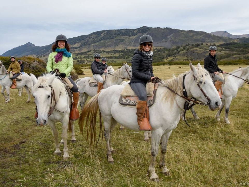 People horseback riding in Patagonia near Hoteles Australis 