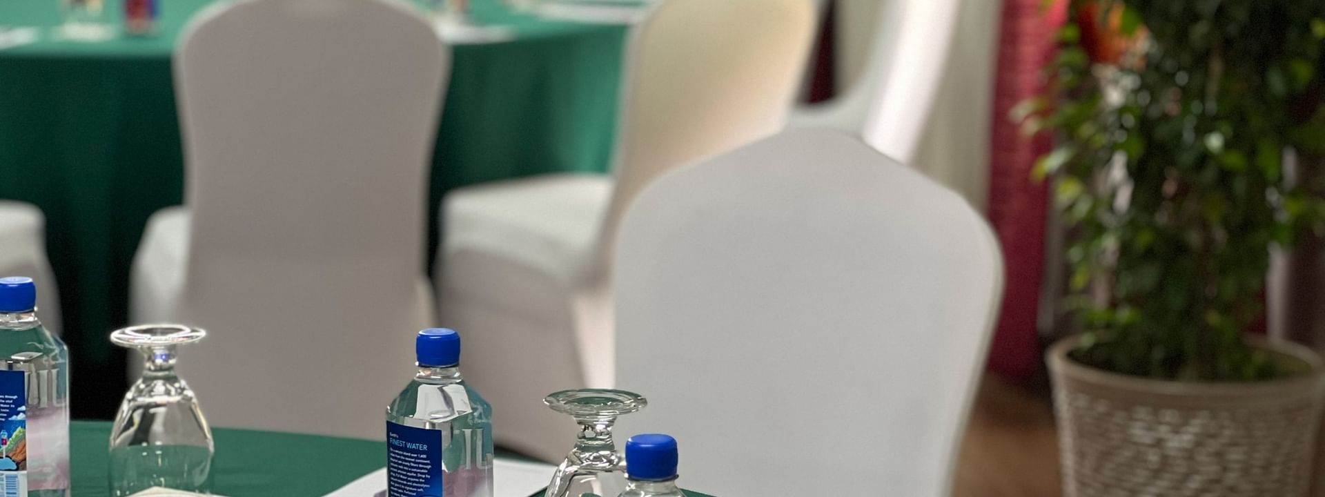 Bottles and glasses on a table in Conference Room 2 at Tokatoka Resort - Fiji International Airport, Nadi
