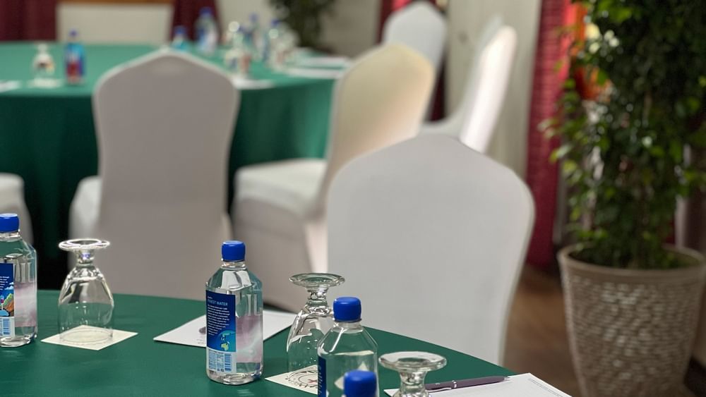 Bottles and glasses on a table in Conference Room 2 at Tokatoka Resort - Fiji International Airport, Nadi.