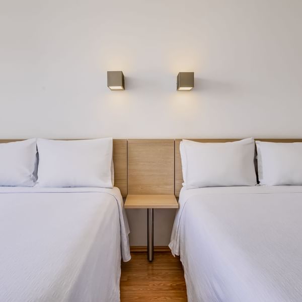 Cozy beds & nightstand in Superior Room 2 Twin at One Hotels