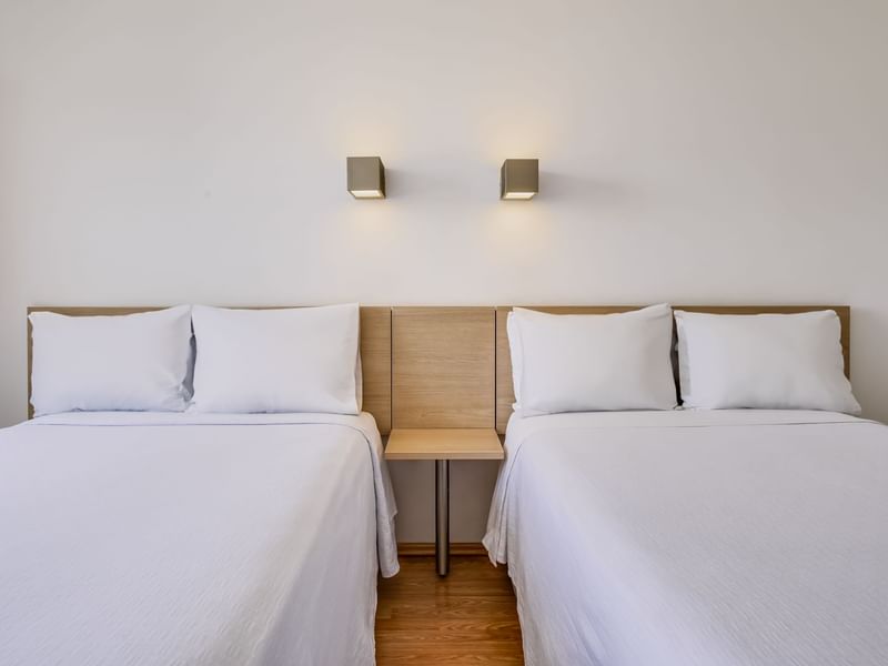 Cozy beds & nightstand in Superior Room 2 Twin at One Hotels