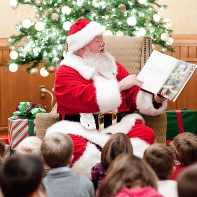 Santa reading to children at Tea With Santa