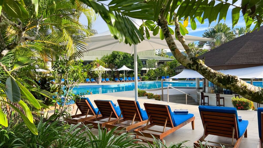 Lounge chairs by the swimming pool at The Naviti Resort in Korolevu.