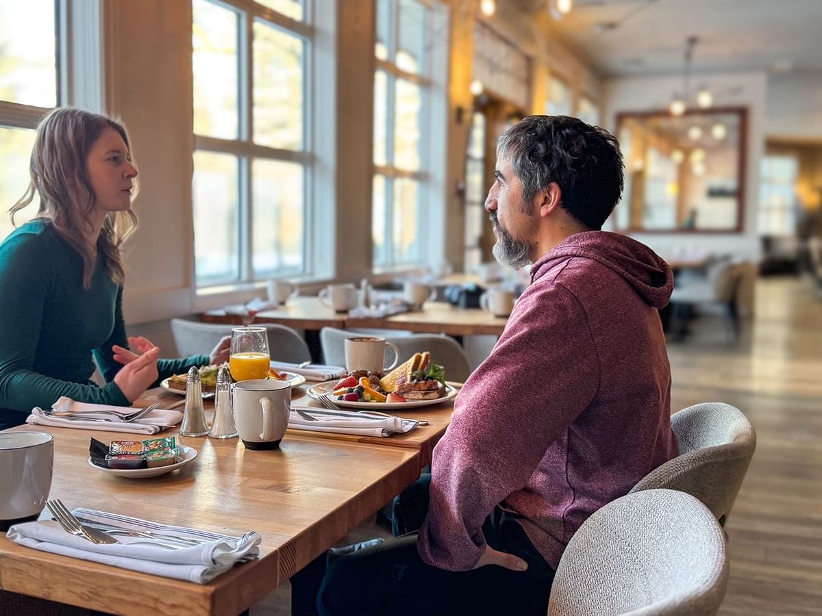 Two guests seated at a table in a restaurant.