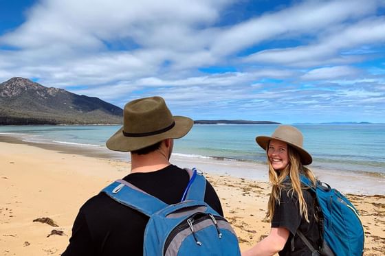 Couple on a walk at Great Oyster Bay near Freycinet Lodge