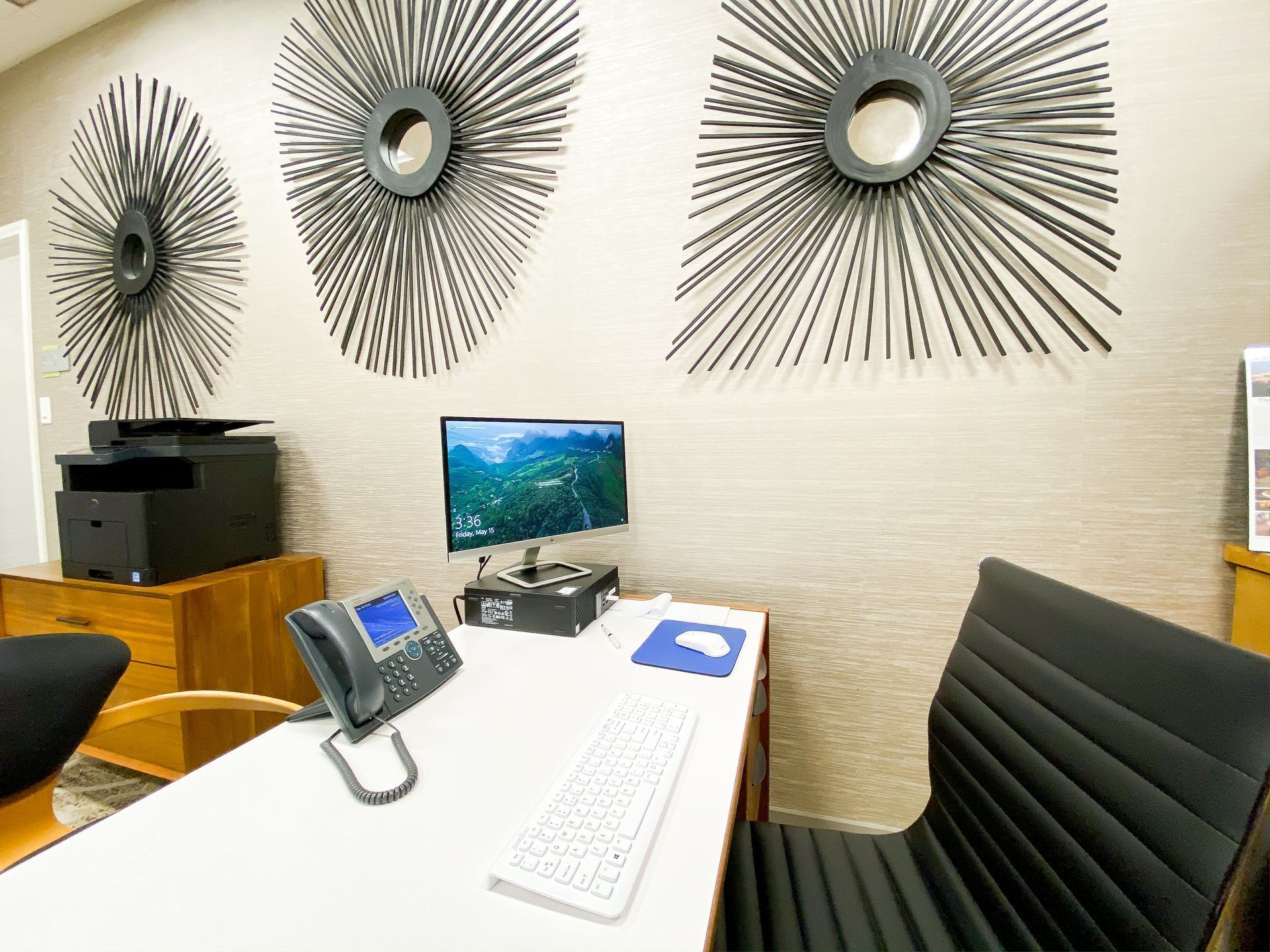 A desk with a computer and phone in the business center at The Fredonia Hotel