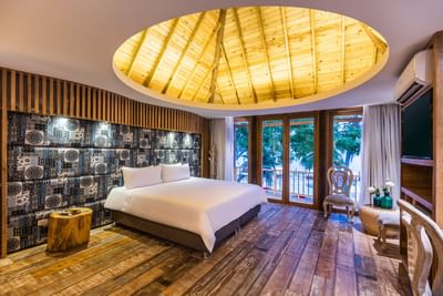 Comfy bed with side tables and wooden ceiling in Master Suite at Hotel Isla Del Encanto