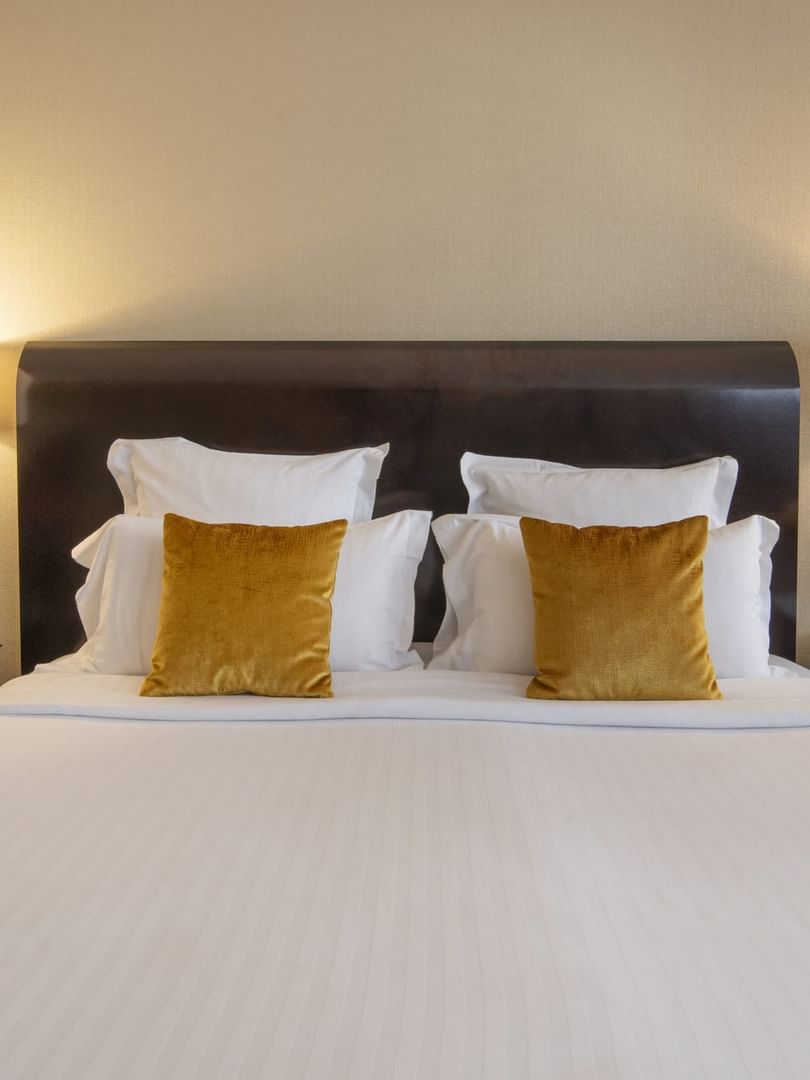 Une chambre Junior Suite à la décoration élégante et dotée d'un lit douillet au Warwick Champs-Élysées Paris.