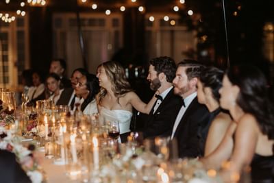 Wedding party seated at a long table with candles at Alderbrook Resort & Spa