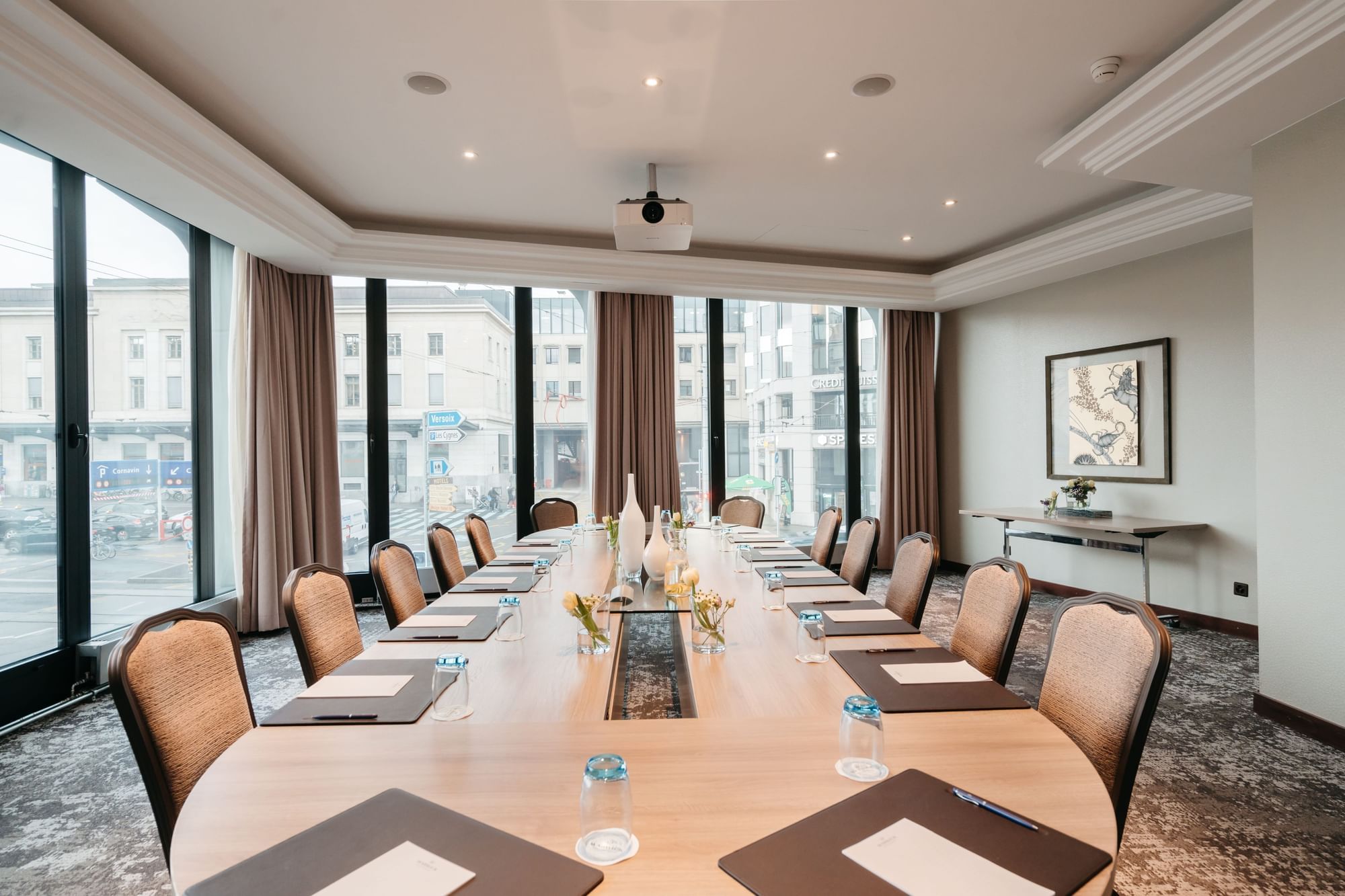 Long table with chairs and city view in Rigi & Cervin at Warwick Geneva