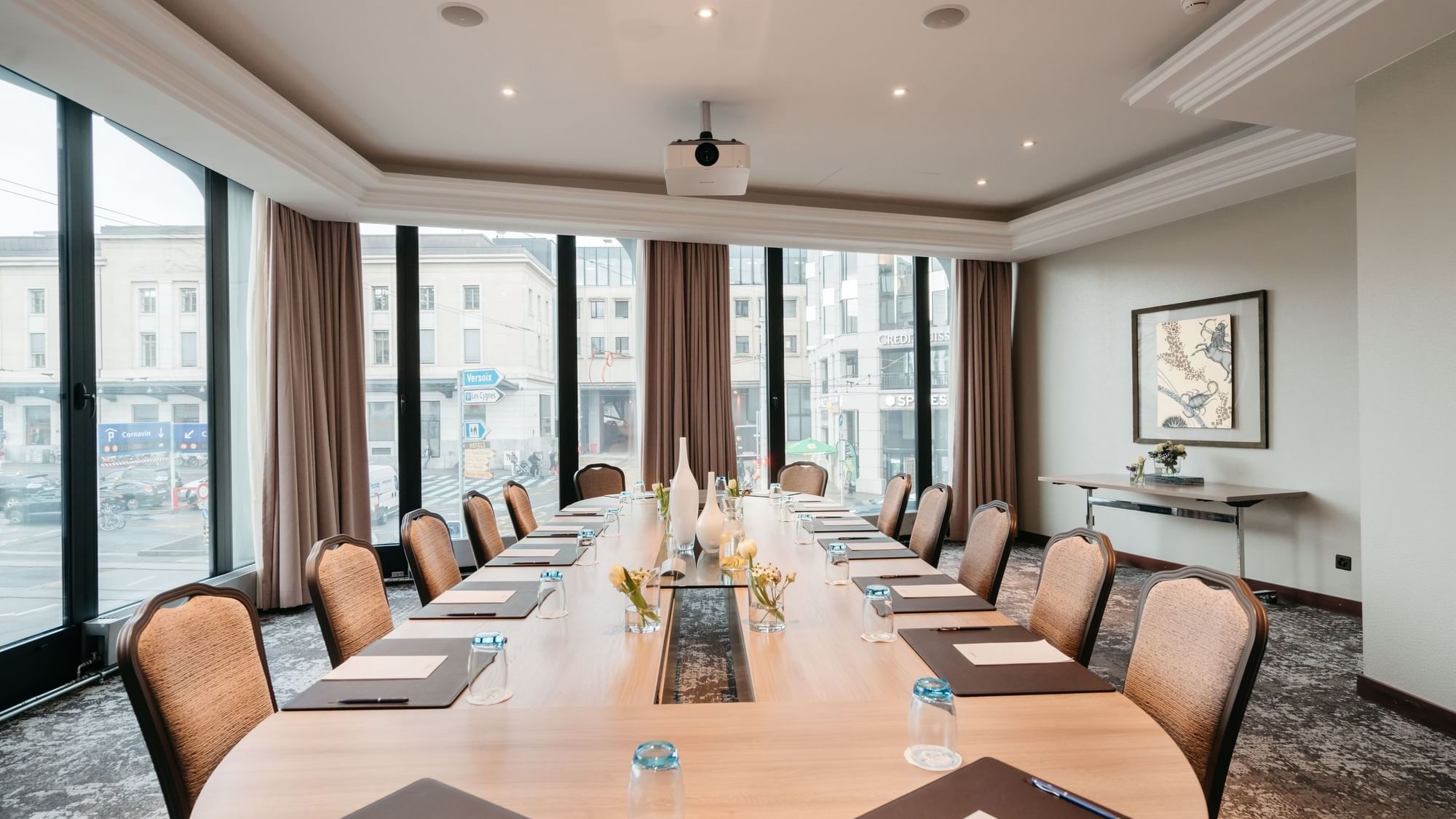Long table with chairs and city view in Rigi & Cervin at Warwick Geneva