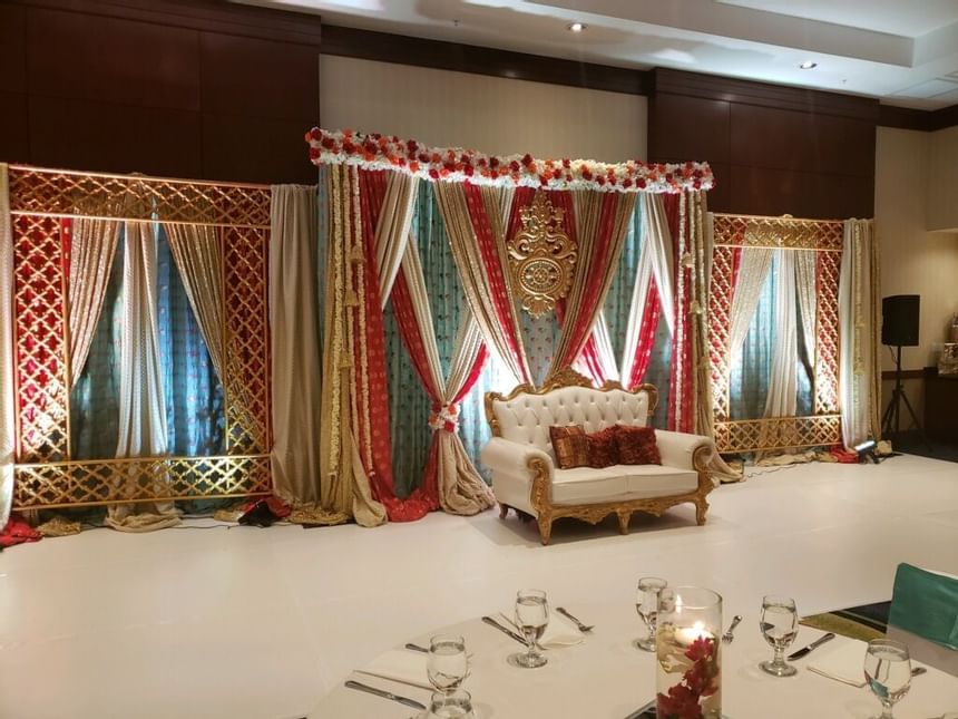 banquet hall with white and gold seating bench and decorative dr