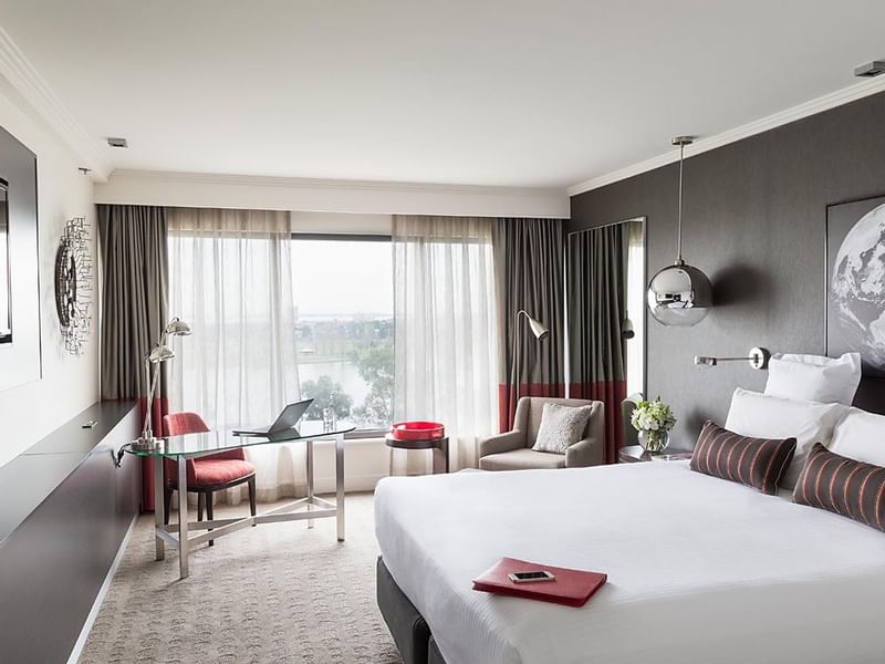 King bed and work area in Classic Room at Pullman Albert Park