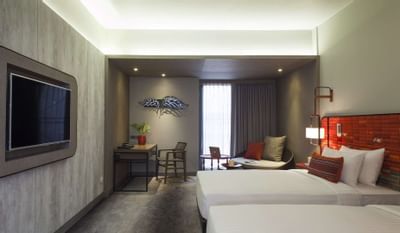 Room with two beds, smart TV and work desk at U Hotels