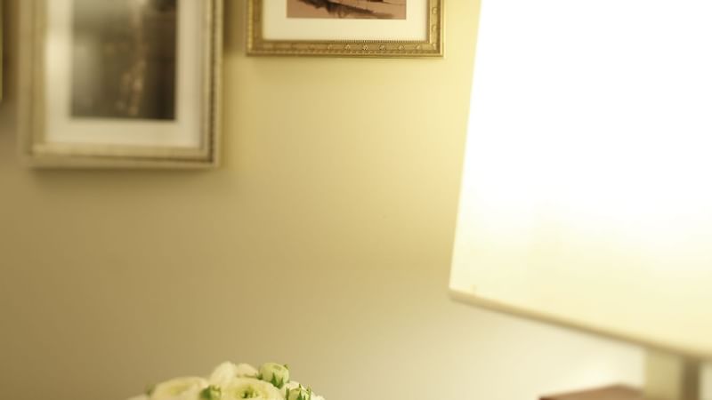 Flowers vase by a table lamp in Hollywood Suite at Warwick New York