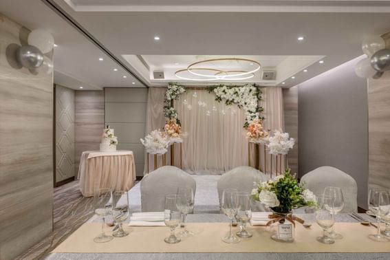 Wedding ceremony arranged with flowers & tables indoors at Park Hotel Hong Kong