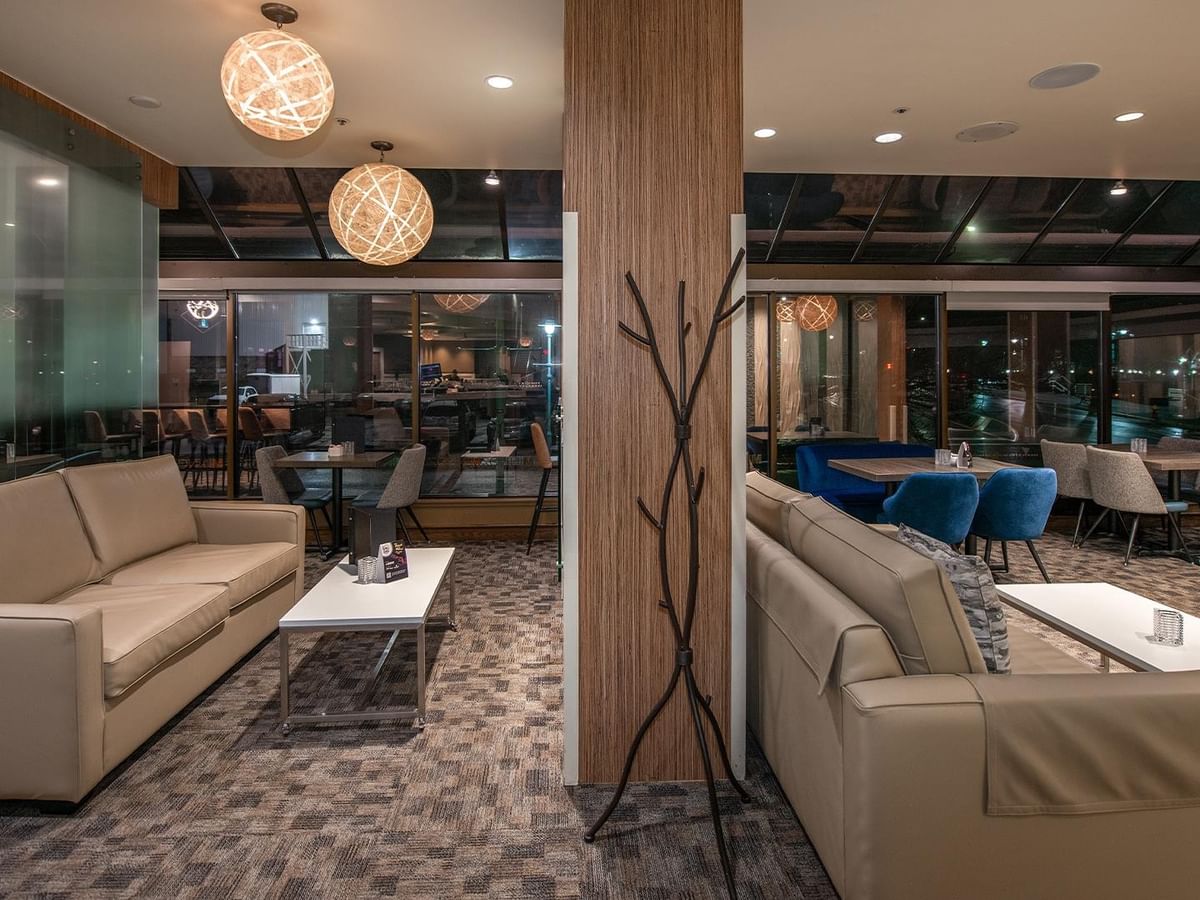 Lounge area with couches and tables at Minnoz Restaurant + Lounge in Nanaimo at Coast Bastion Hotel.