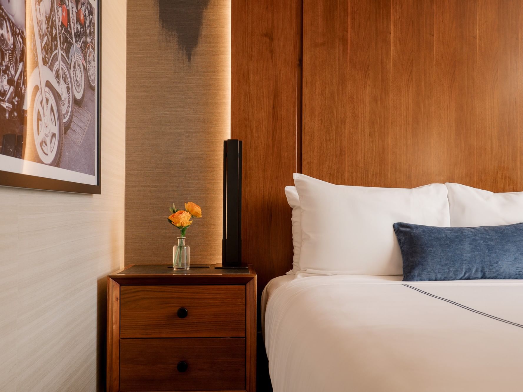 Accessible Superior Room with wooden bed and vase at Gansevoort Meatpacking NYC in New York.