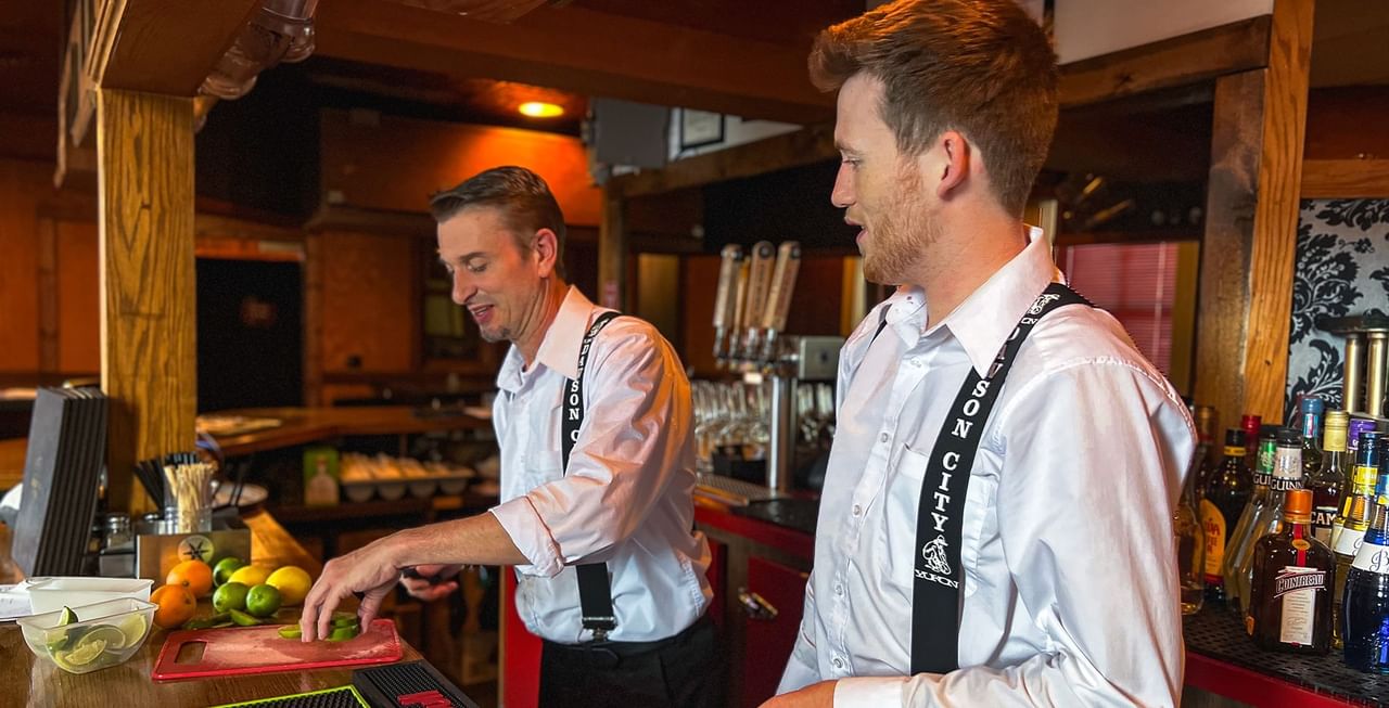 Bartenders preparing a drink in Gallery Restaurant at Midnight Sun, a Coast Hotel