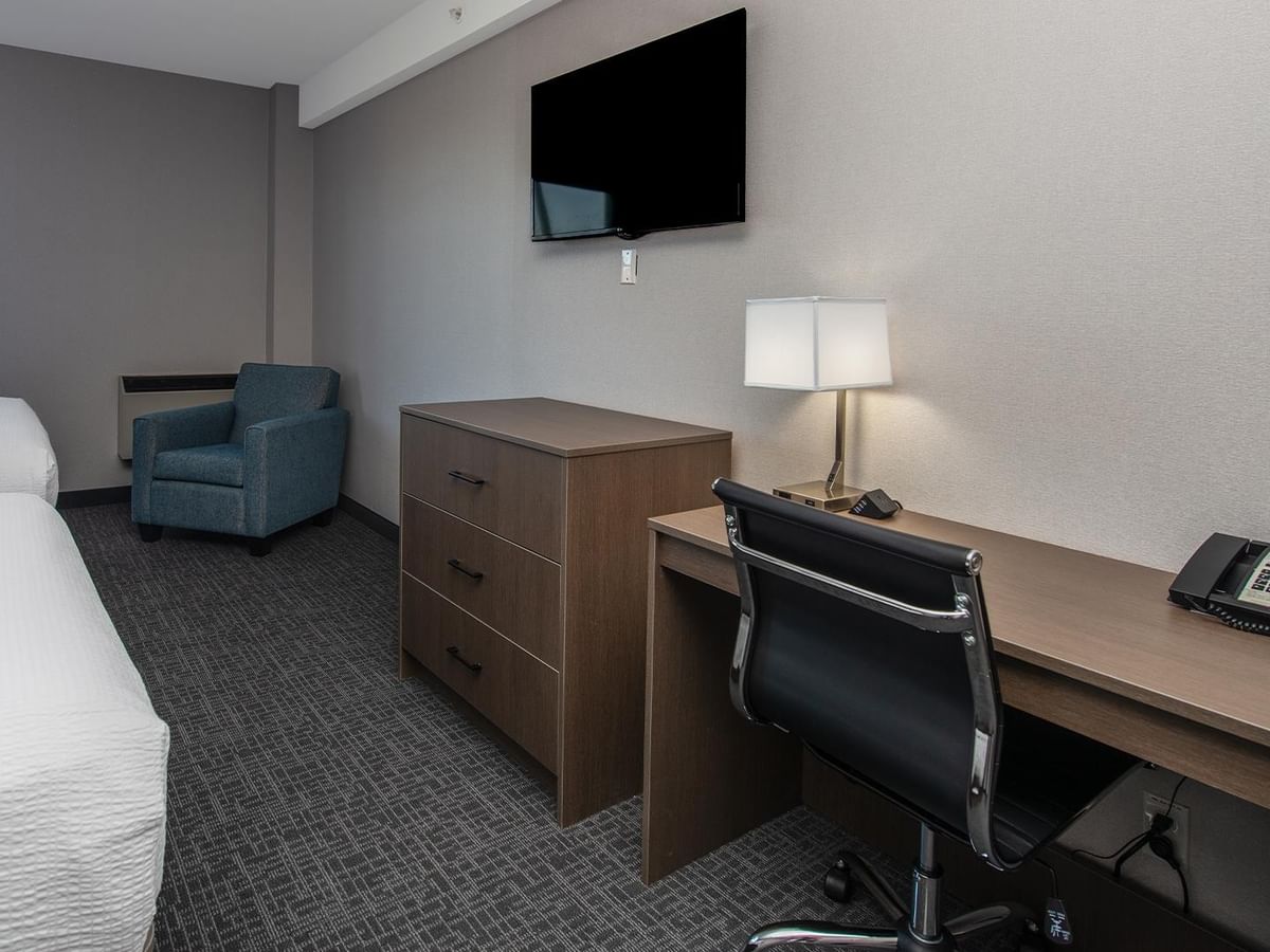 Two queen beds, desk, chair, TV, and telephone.