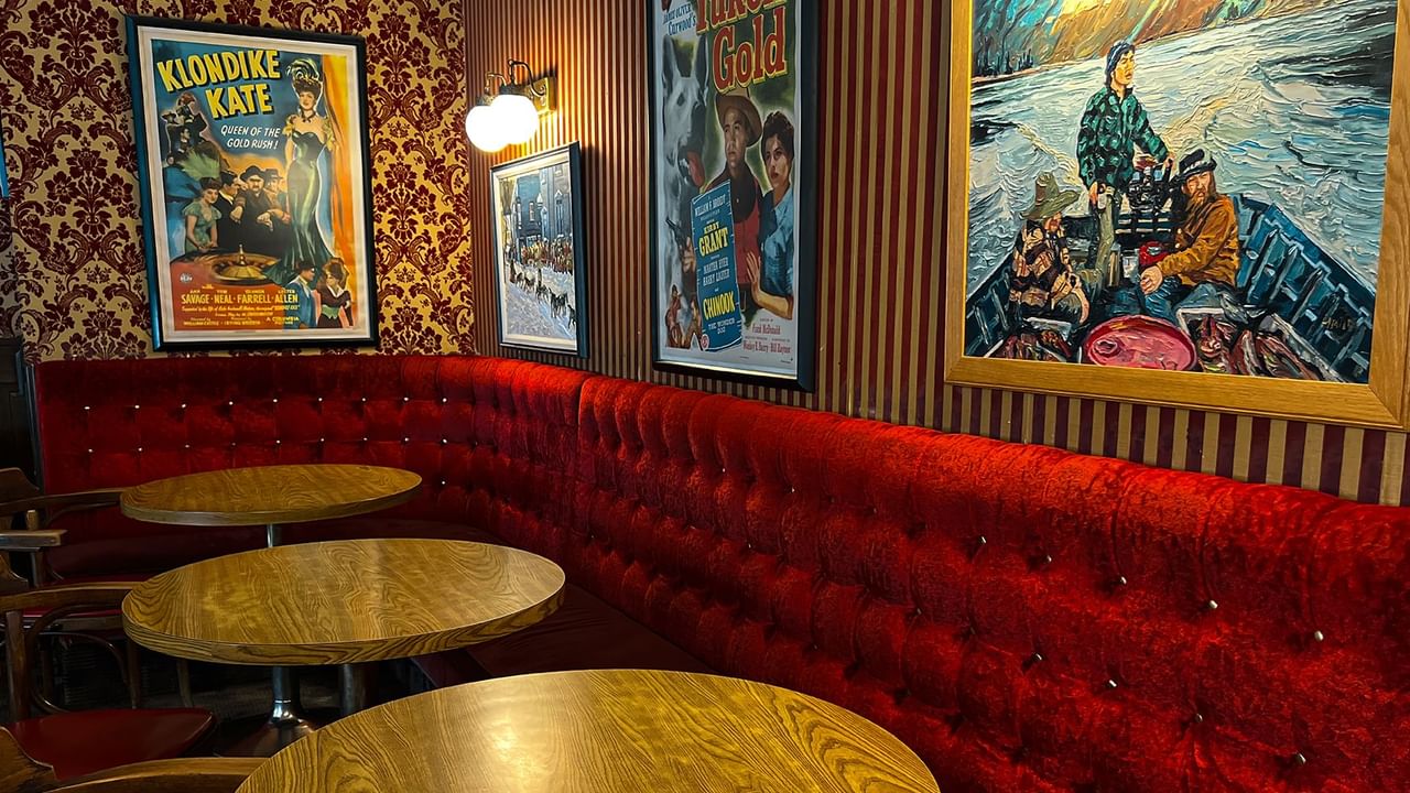 Interior of Sourdough Saloon with painting, poster, sofa, and table