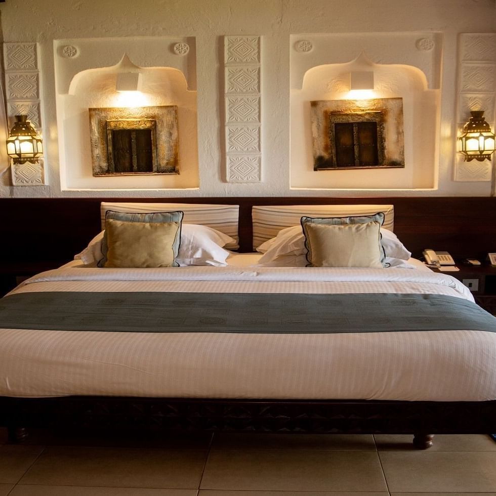 Spacious Family Room with large bed, pillows, and elegant decor at Serena Beach Resort & Spa Mombasa.