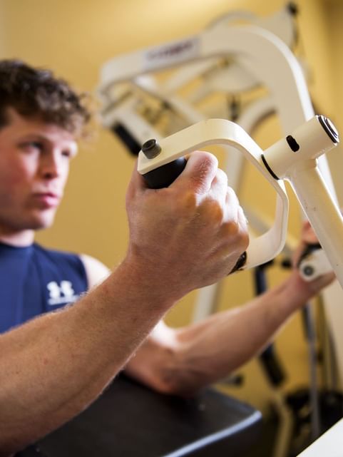 Man working out with the fitness equipment in the Gym at Cove Pocono Resorts