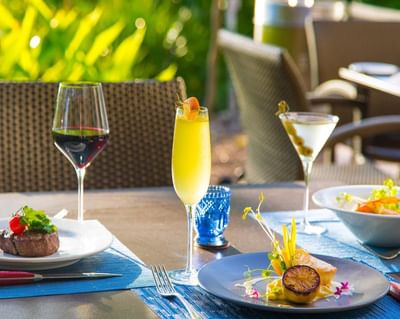 Cocktails & wine served with scallops & steak dishes at Trianon Bonita Bay