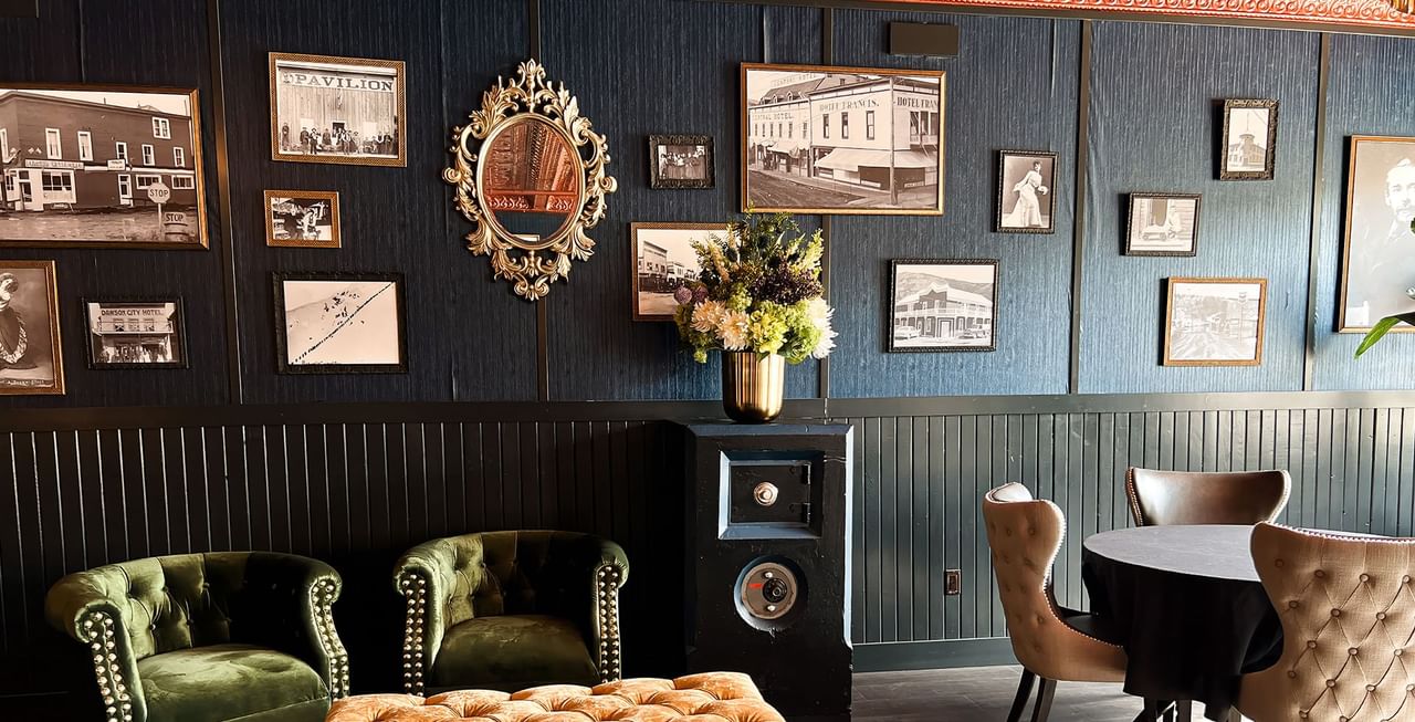 Hotel lobby with vintage photos, couches, tables, chandelier, and decoration at Midnight Sun, a Coast Hotel