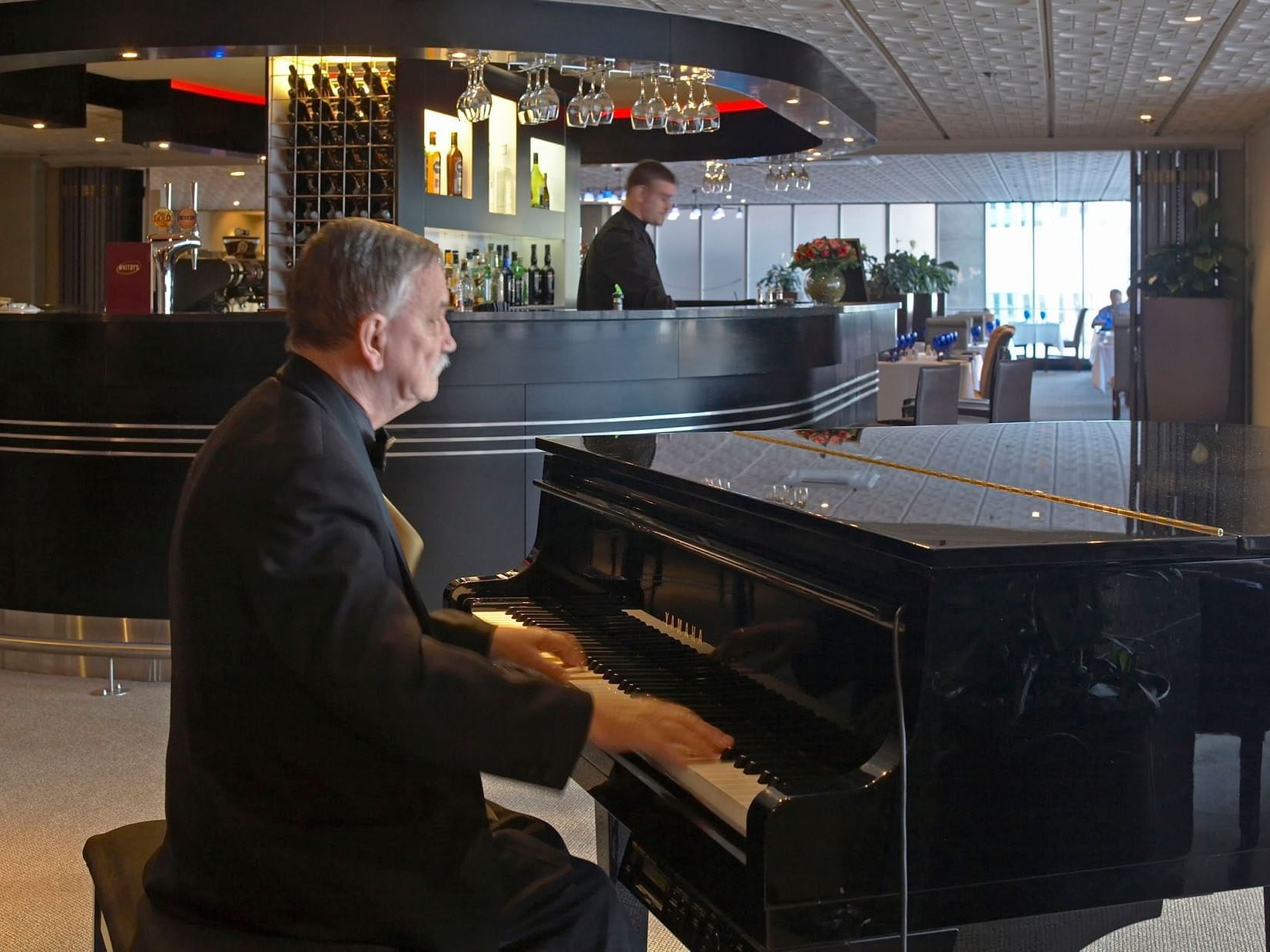 Man playing the piano in Whitby's Restaurant & Bar at James Cook Hotel