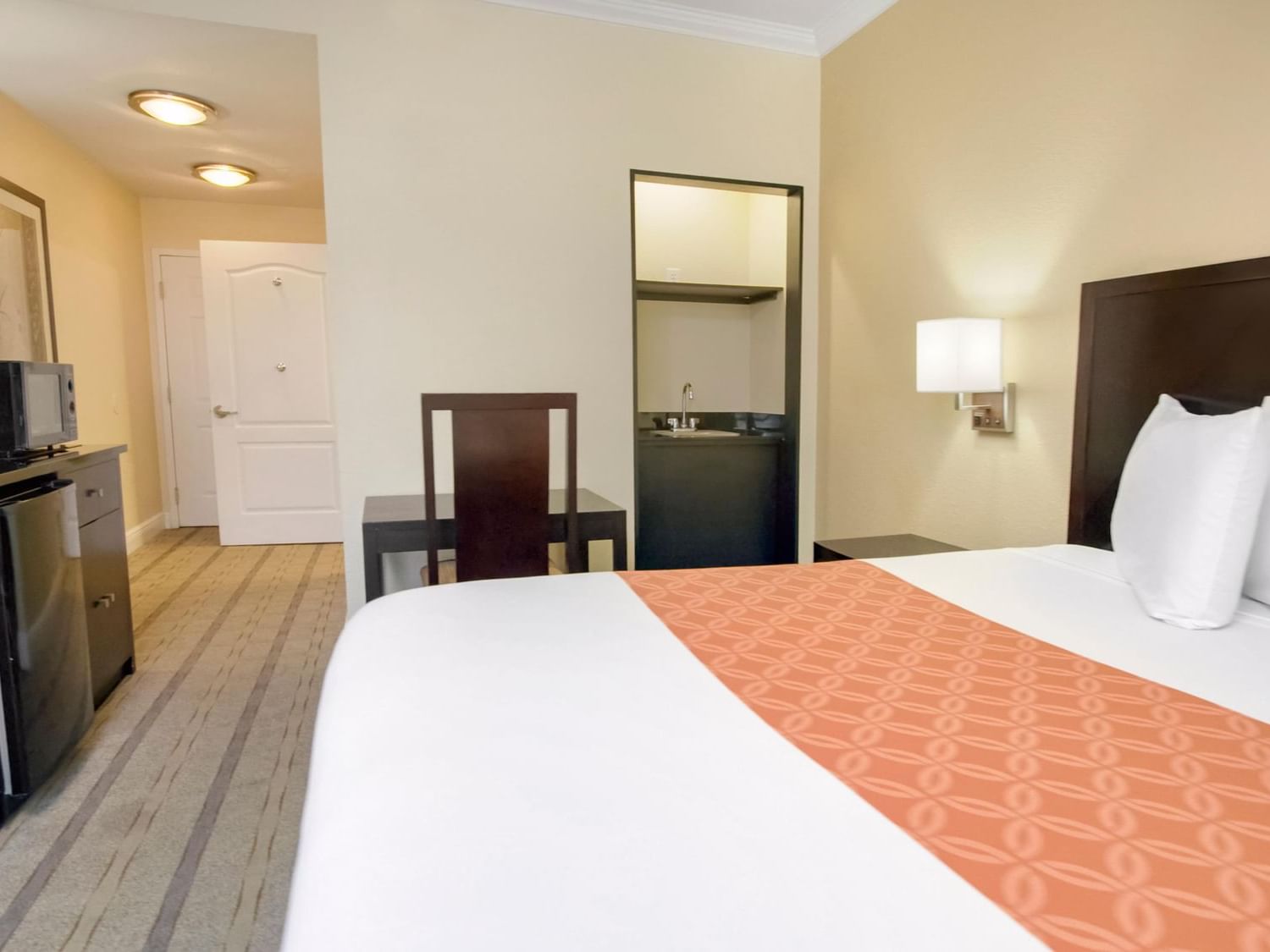 Bedroom at ADA king room accessible at Galleria Palms Hotel
