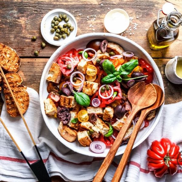 Mediterranean salad with olives, tomatoes, and croutons in a bowl served at Falkensteiner Hotels & Residences