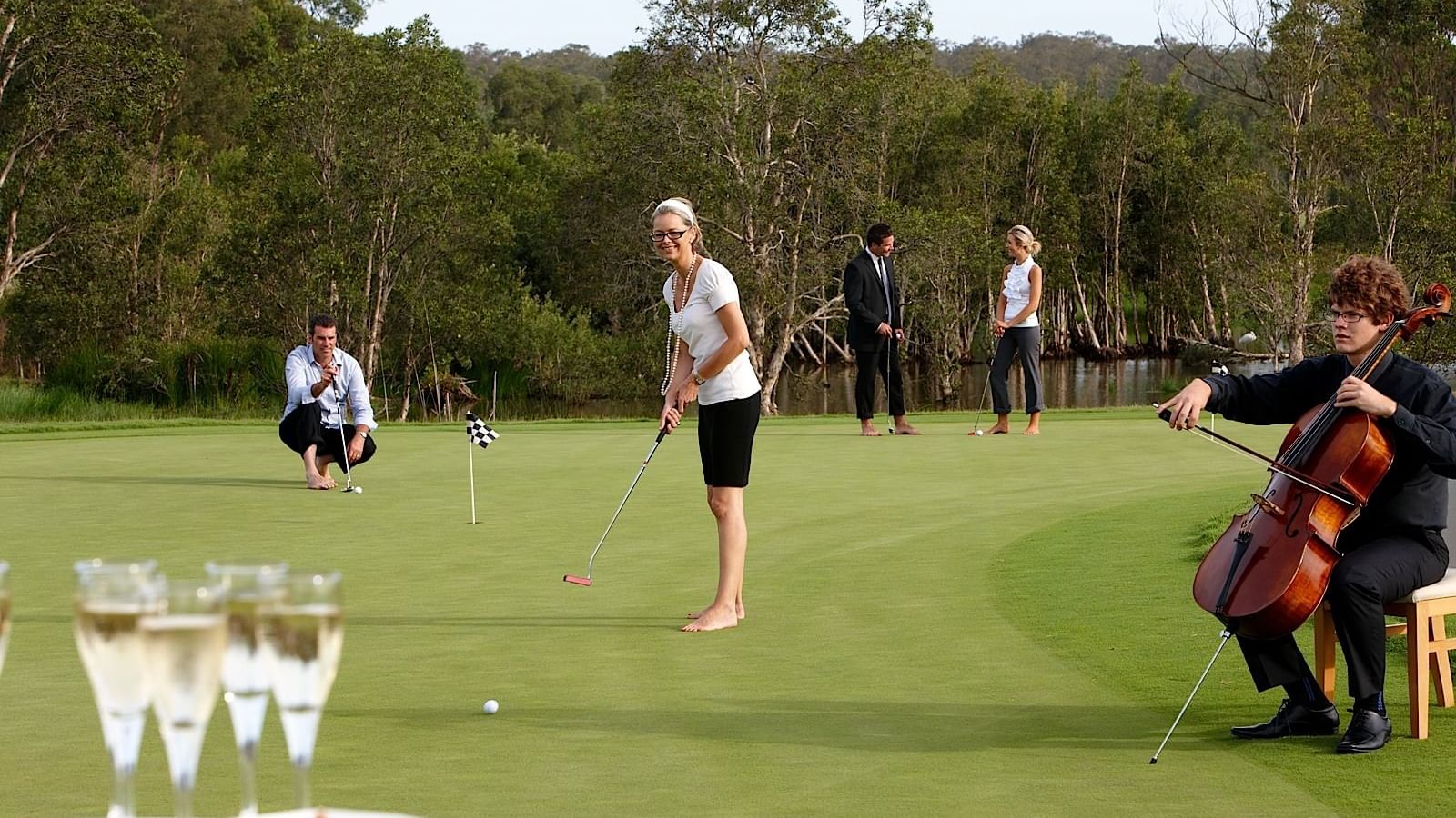 woman playing golf and a man playinh music at Mercure Kooindah Waters