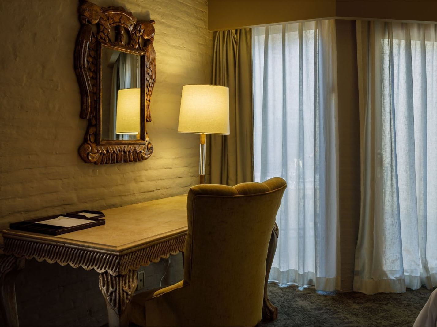 King Presidential Suite Classic wooden writing desk and ornate mirror at Quinta Real Guadalajara