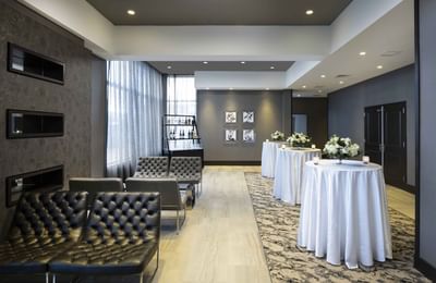 waiting area with small bar tables and seating