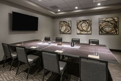 boardroom with long table, chairs and television