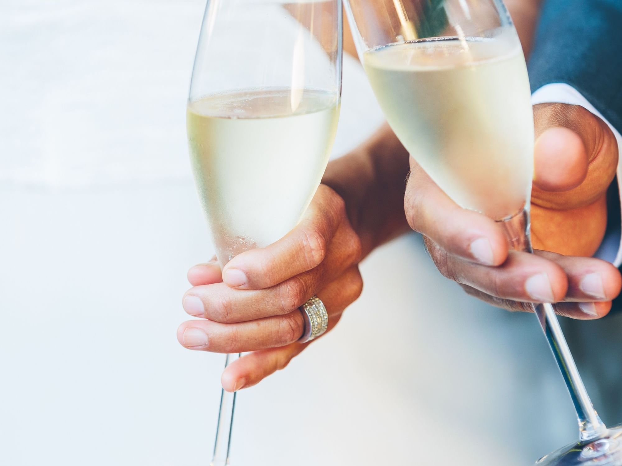 Close-up of couple toasting wine at Amora Hotel Melbourne