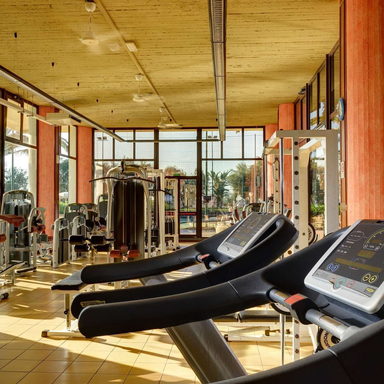 Fitness room with natural daylight and personal trainer.