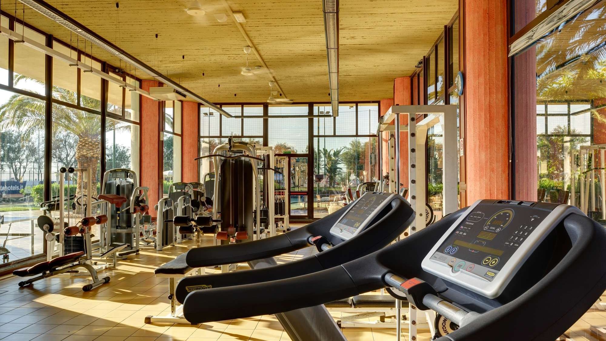 Fitness room with natural daylight and personal trainer.